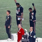 The american sprinters Tommie Smith,John Carlos and Peter Norman during the award ceremony of the 200 m race at the Mexican Olympic games. During the awards ceremony, Smith and Carlos protested against racial discrimination: they went barefoot on the podium and listened to their anthem bowing their heads and raising a fist with a black glove. Mexico City, Mexico, 1968 Mexico city, Mexico, 1968